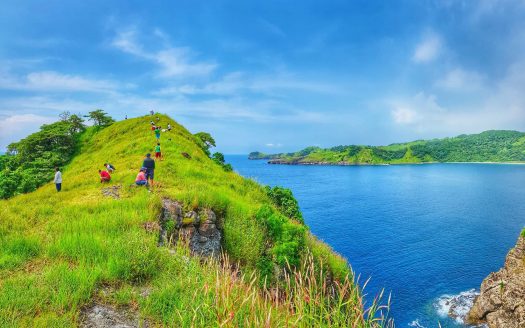 an overview shot of a cliff with beautiful blue water